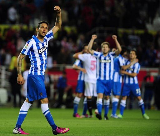 Real Sociedad's Liassine Cadamuro-Bentaiba (L) celebrates win against Sevilla, on May 18, 2013